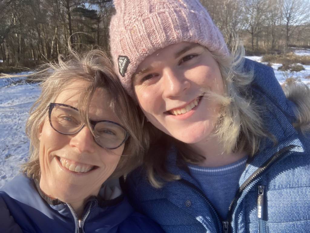 Alice Litman and her mum smiling, with snow visible on the ground behind them