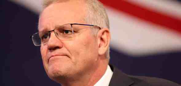 Scott Morrison stood in front of an Australian flag