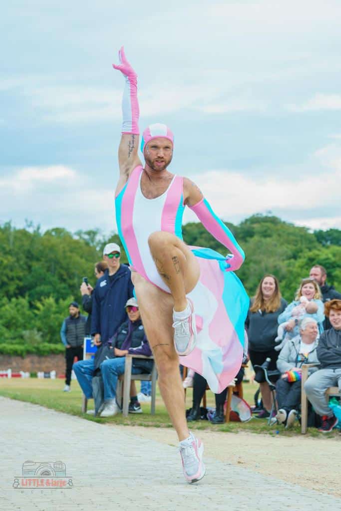 Man with arm in the air wearing swimsuit 