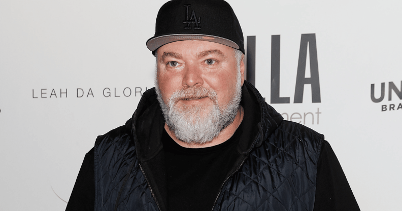 Kyle Sandilands stands for a red carpet photoshoot.