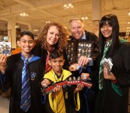 Coles customers hold packs of the collectable Harry Potter Magical Builders