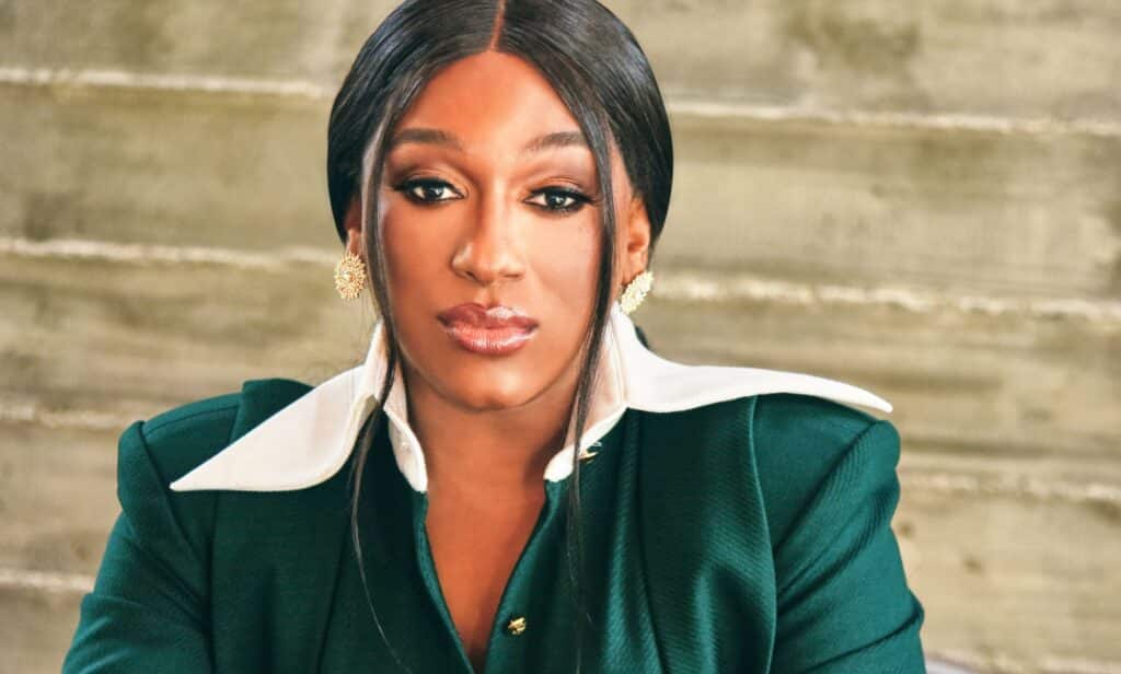 Elle Moxley, founder and executive director of Marsha P Johnson Institute, looks into the camera while wearing a green and white outfit