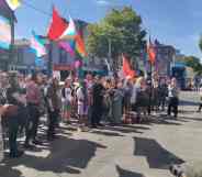 A crowd of LGBTQ+ activists and allies gather outside the Independent House