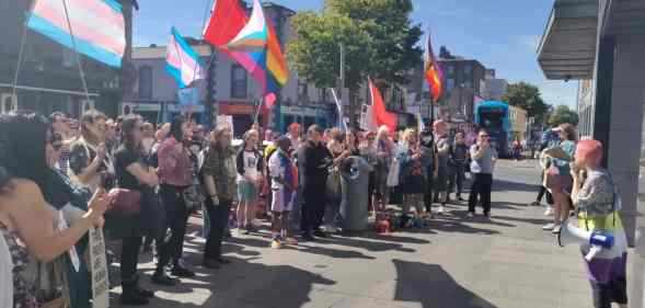 A crowd of LGBTQ+ activists and allies gather outside the Independent House