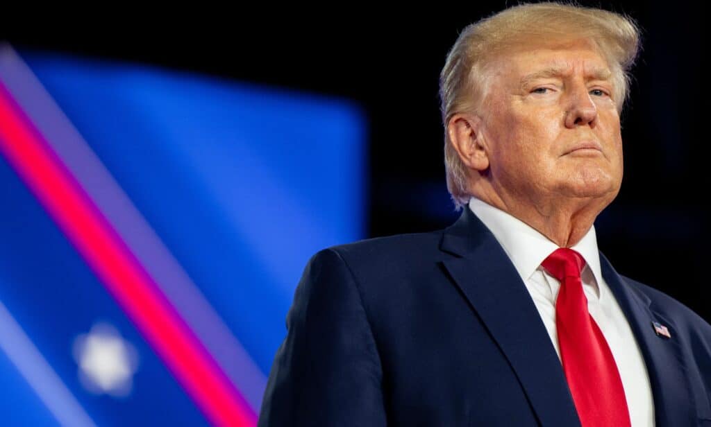 Donald Trump wears a suit and tie as he speaks during a conference