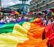 A Birmingham Pride procession goes through the city's gay village with LGBTQ+ flags