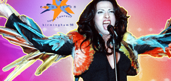 Dana International singing in front of the Eurovision 98 logo