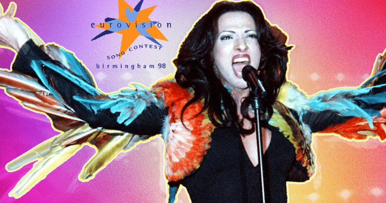 Dana International singing in front of the Eurovision 98 logo