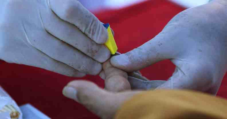 Someone taking a fingerprick test.