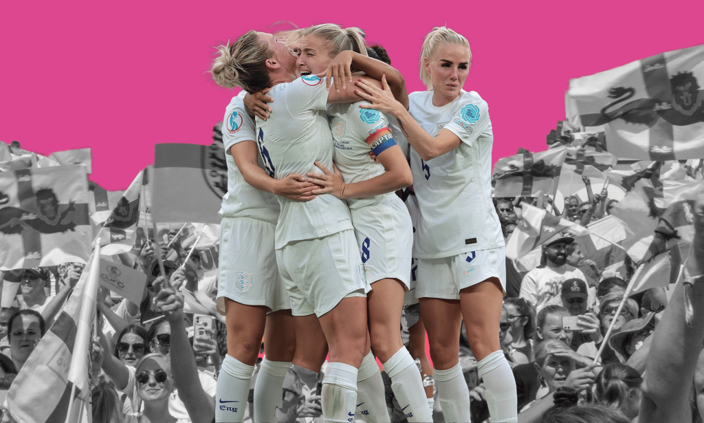 The England women's team embrace against a backdrop of black and white fans