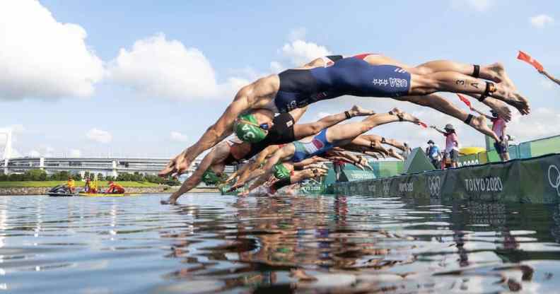 Athetes dive during the mixed relay Triathlon competition at the 2020 Tokyo Olympic Games