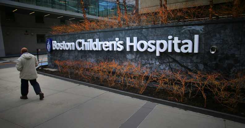 In this photograph, a pedestrian passes the Longwood Avenue exterior of the Boston Children's Hospital