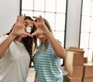 This stock photo shows a lesbian couple hold keys to a new home.