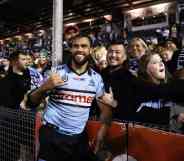 Toby Rudolf of the Sharks celebrates with fans after the round 20 NRL match between the Cronulla Sharks and the South Sydney Rabbitohs