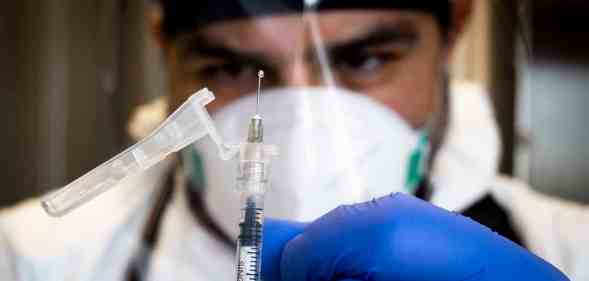 In this photograph, a medic repares a dose of the monkeypox vaccine