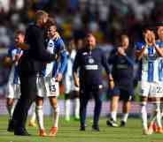 Graham Potter, manager of Brighton and Hove Albion celebrates with Pascal Gross