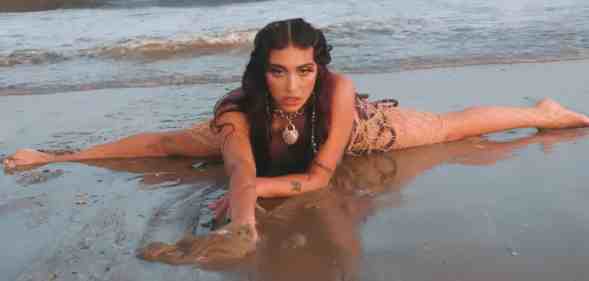 Lourdes Leon as Lolahol on a beach in her new music video