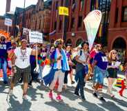 A scene from 2019 Manchester Pride event showing people marching on the streets