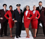 Various fashion icons, including Michelle Visage, pose in an airport runway.