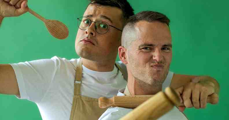 Great British Bake Off stars Michael Chakraverty and David Atherton pose with cooking utensils