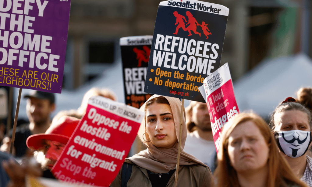 Several activists gather together to protest proposals by the UK government to deport some migrants to Rwanda