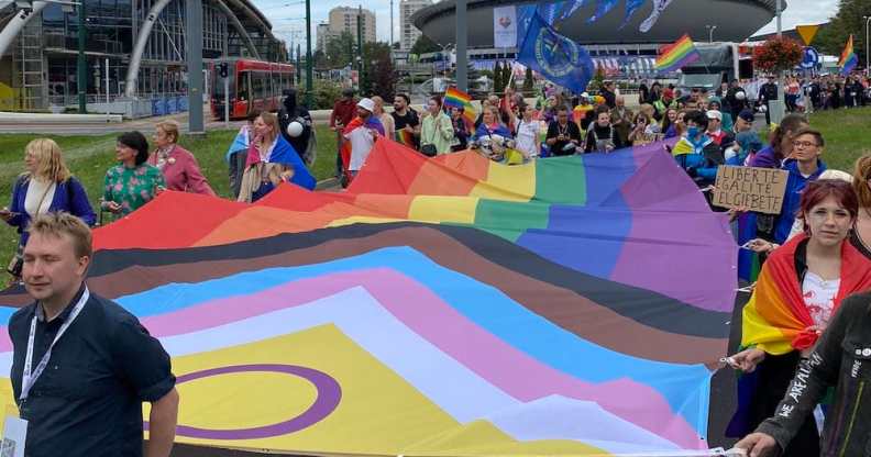 Pride-goers carry a giant Pride flag in Katowice, Poland