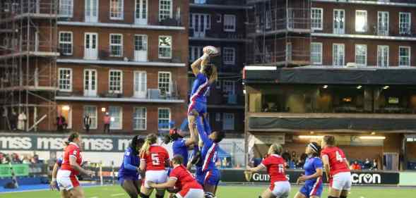 Female rugby in the air catching the ball