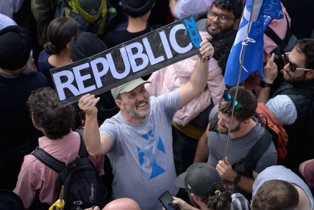 A anti-royalist protester in the crowd during a Accession Proclamation Ceremony at Mercat Cross. 