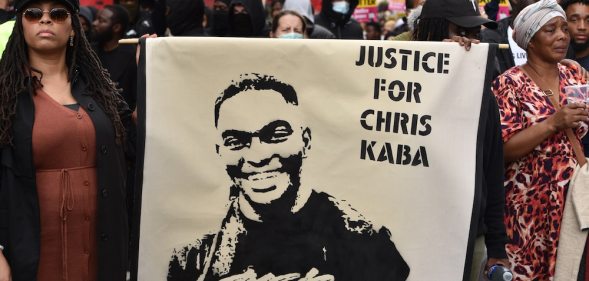 Protesters hold a banner that reads "justice for Chris Kaba" during a march in London