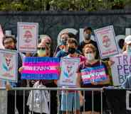 A group of LGBTQ+ activists hold banners promoting trans rights at Boston Children's Hospital where a bomb threat was made a few weeks ago