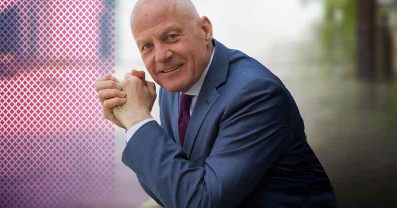 Michael Cashman pictured outdoors wearing a navy suit.