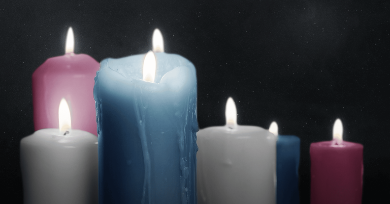 Lit candles in the colours of the trans Pride flag