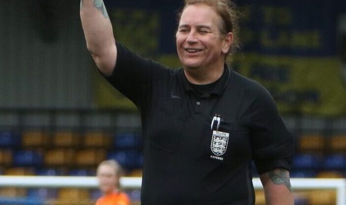 Trans football referee Lucy Clark smiles as she officiates a match