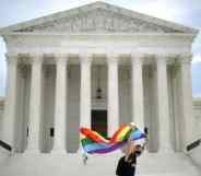 Joseph Fons holding a Pride Flag, walks back and forth in front of the U.S. Supreme Court