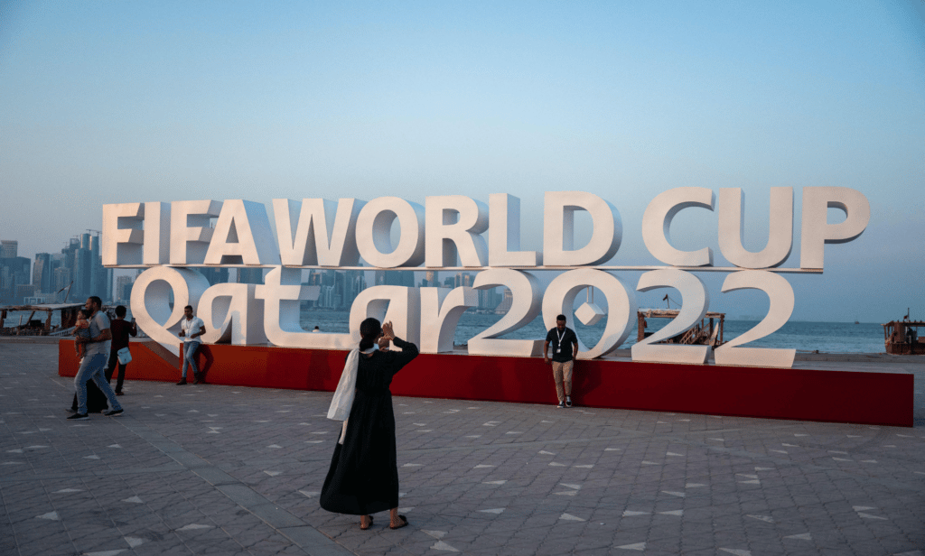 Visitors take photos with a FIFA World Cup sign in Doha, Qatar