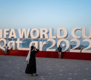 Visitors take photos with a FIFA World Cup sign in Doha, Qatar