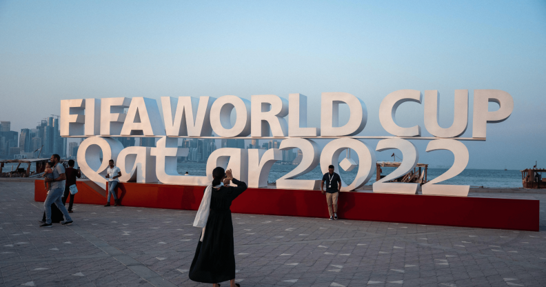 Visitors take photos with a FIFA World Cup sign in Doha, Qatar