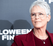 Jamie Lee Curtis wears a red outfit at a press event