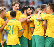 Players from the Australia national football team, known as the Socceroos, huddle together in a match. Several players from the team released a statement denouncing Qatar's human rights record ahead of the World Cup in November