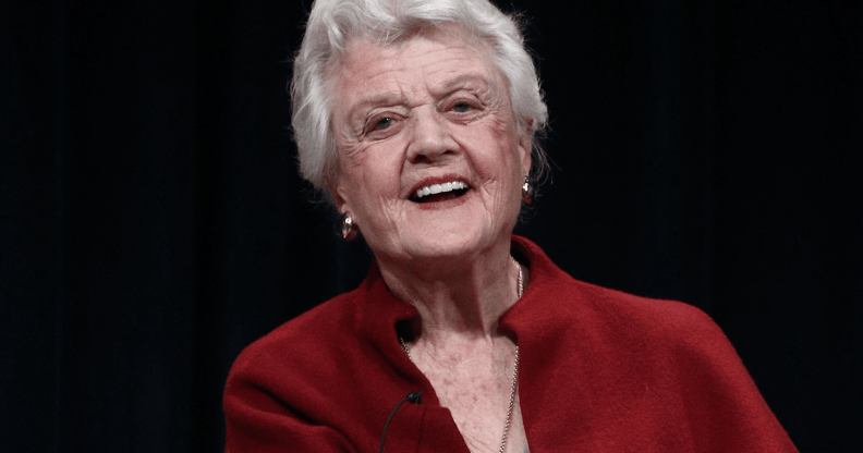 Angela Lansbury wears red as she smiles for the camera