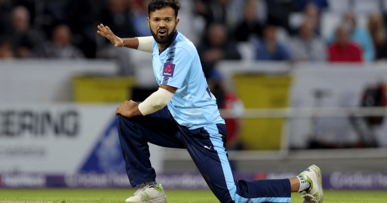 Azeem Rafiq wears a blue uniform as he plays cricket for Yorkshire