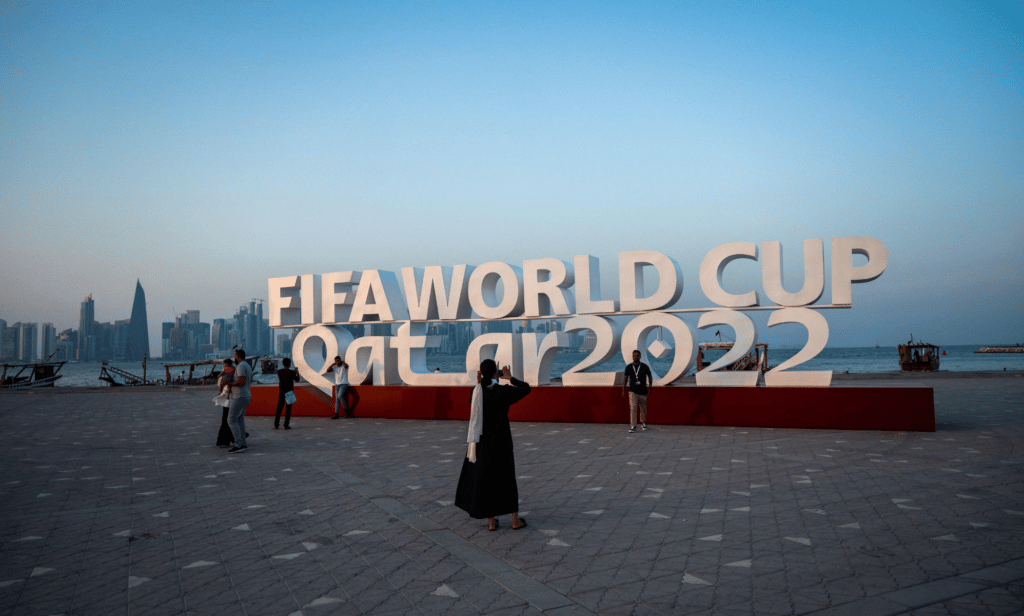 Visitors take photos with a FIFA World Cup sign in Doha, Qatar