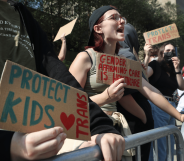 Several people gather outside to show their support for gender-affirming healthcare for trans youth in the US