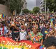 People walk in the streets during the Johannesburg Pride Parade on October 29, 2022 in Johannesburg.