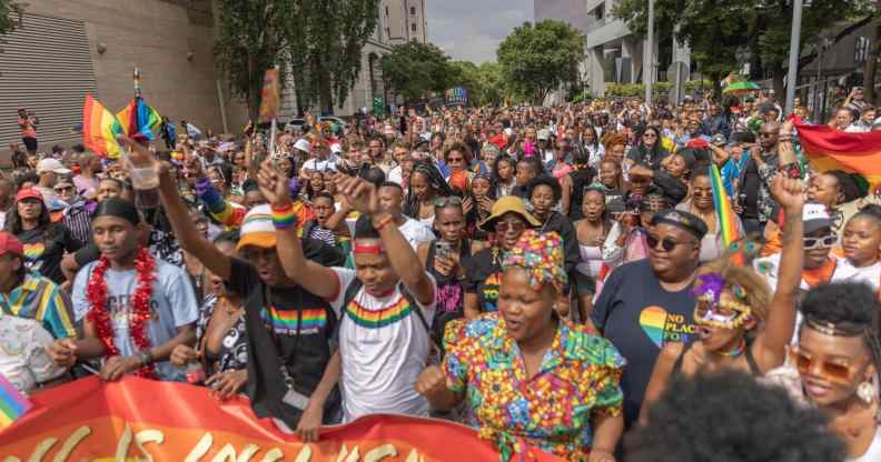 People walk in the streets during the Johannesburg Pride Parade on October 29, 2022 in Johannesburg.