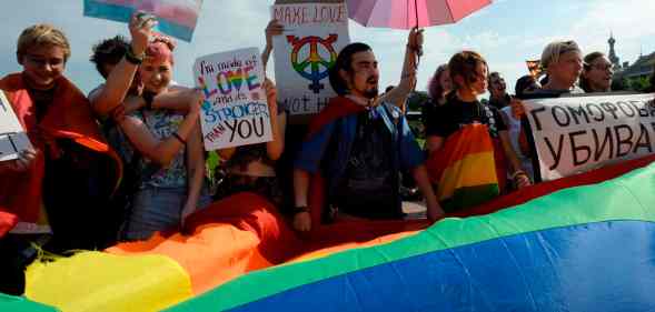 People wave Pride flags during the gay pride rally in Saint Petersburg