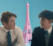 A graphic image shows actors Kit Connor and Joe Locke superimposed in front of a pink image of the Eiffel Tower