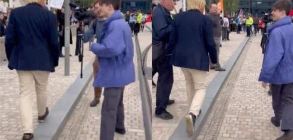 A protester approaching Michael Fabricant as he makes his way into the Conservative Party's conference in Birmingham.