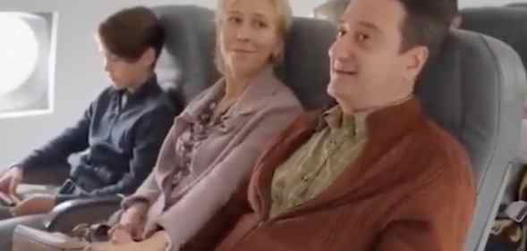 A man, woman and child are seen in a video allegedly produced by the Russian Federation. They are seated on a plane as the husband and wife speak to each other.