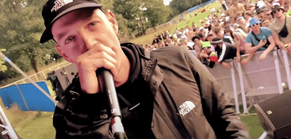 A screenshot of Welsh rapper Mr Traumatik performing at a festival